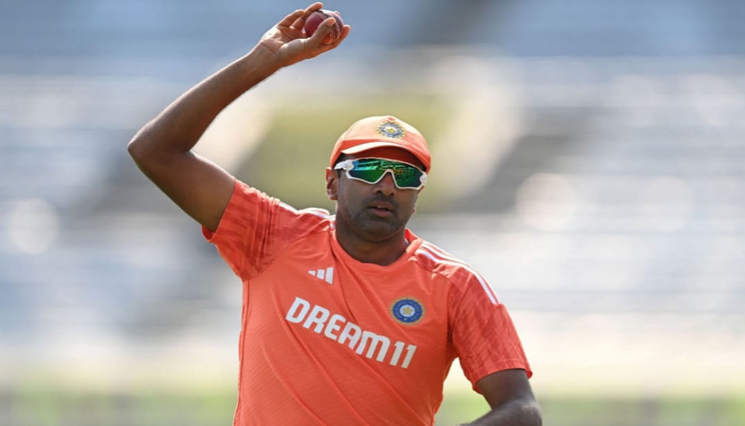 R. Ashwin raising the ball after achieving 300 wickets in Test cricket