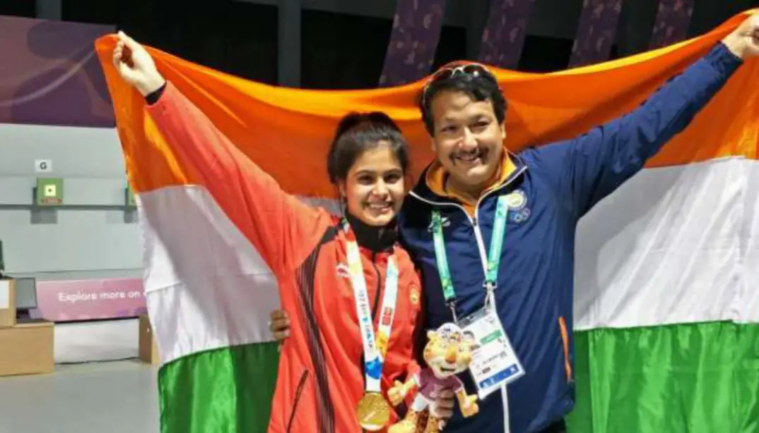 A close-up of Manu Bhaker holding her bronze Olympic medal, its intricate details gleaming against a backdrop of the Indian flag, symbolizing her national pride.