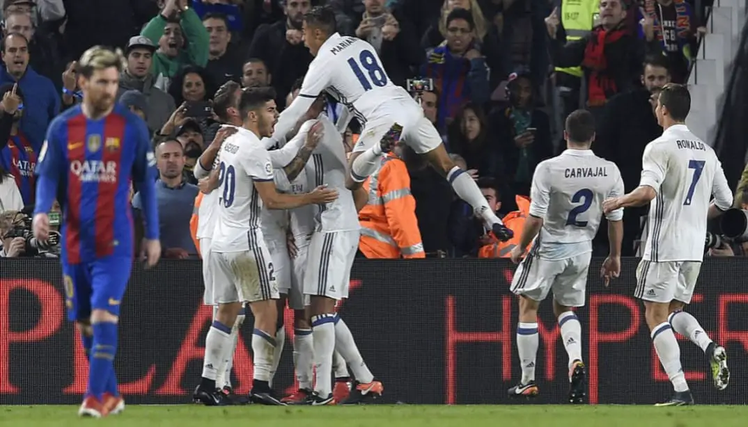 Truly beaten Barcelona: Real Madrid players celebrating a goal at Camp Nou with Barcelona fans in the background.