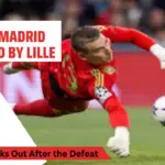 Andriy Lunin in Real Madrid jersey expressing frustration after a goal is conceded during the match against Lille.