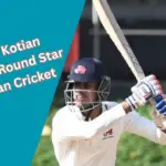 Tanush Kotian showcasing his batting skills during a Ranji Trophy match, epitomizing his all-round cricketing prowess.