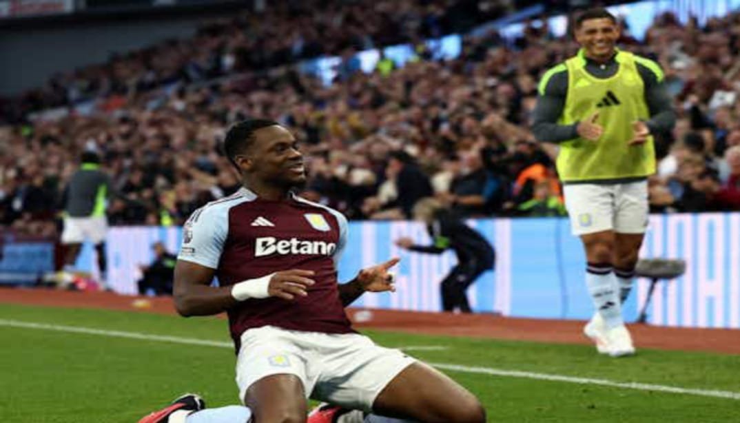 Jhon Durán scoring a goal in Aston Villa's home kit during a Premier League match.