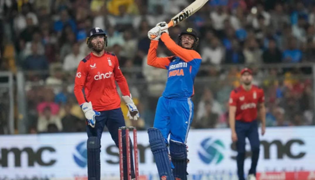 Abhishek Sharma mid-swing, launching the ball into the stands at Wankhede Stadium.