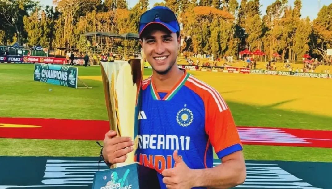 Abhishek Sharma is holding the Player of the Match trophy, smiling confidently.