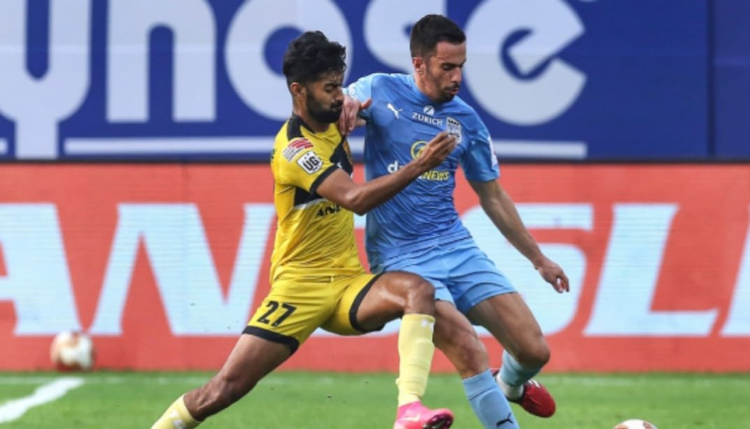 Hyderabad FC vs Mumbai City FC players battling for possession.