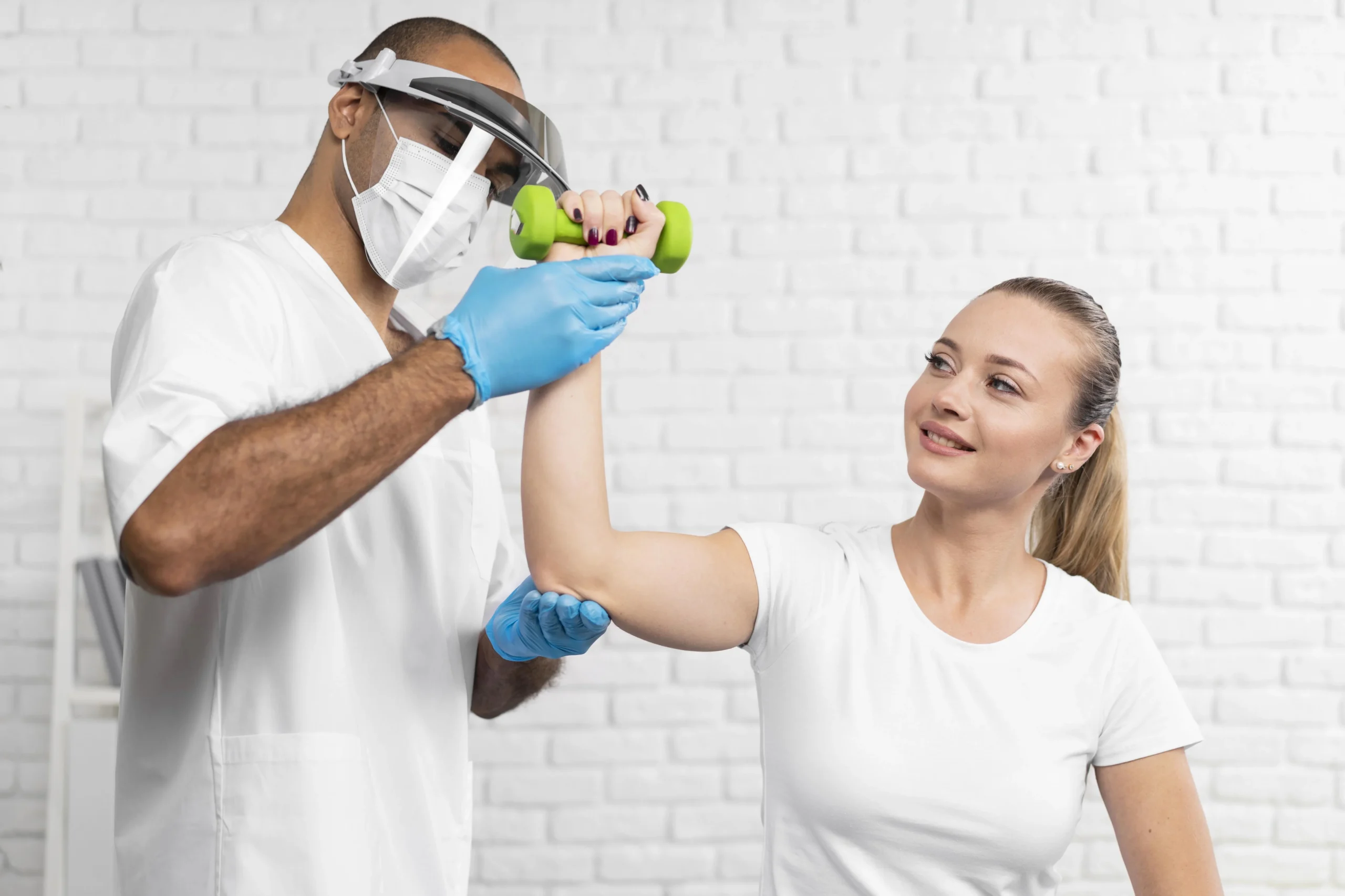 Male physiotherapist checking woman strength